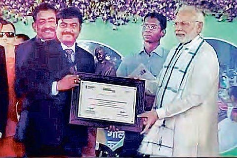 Screen grab of VMC commissioner J Nivas receiving Swachh Bharat award from Prime Minister Narendra Modi at Indore on Saturday