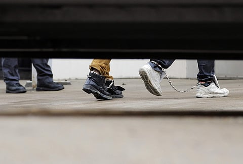 Immigrants in ankle chains disembark from a bus at the Federal Courthouse for hearings on Friday, June 22, 2018, in McAllen, Texas. (Photo | AP)