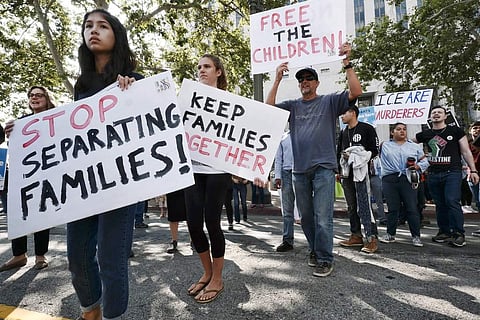 Protestors carry signs and chant slogans in front of Federal Courthouse in Los Angeles on Tuesday, June 26, 2018. | AP