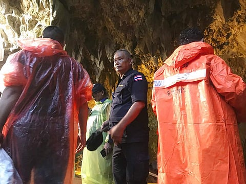 Rescue workers gather at the entrance of a cave in Mae Sai, Chiang Rai province, northern Thailand. ( Photo | AP )