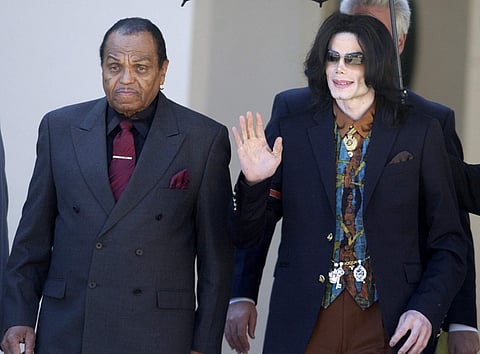 In this March 15, 2005 file photo, Pop star Michael Jackson leaves the Santa Barbara County Courthouse with his father, Joe, in Santa Maria, Calif., following a day of testimony in Jackson's trial on charges of child molestation. Joe Jackson, the patriarc