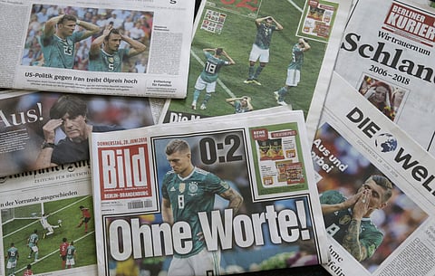 A pile of German newspapers from the day after Germany was knocked out of the FIFA World Cup, this year. (AP)