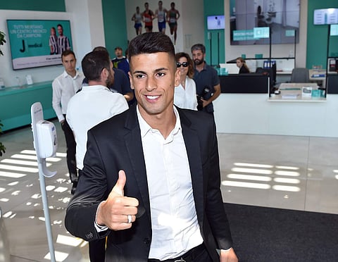 Portuguese player Joao Cancelo gives the thumbs up as he arrives at Juventus Medical center. | AP
