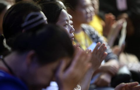 Parents and relatives pray and hope for the best outside the caves in Chiang Rai (File | AP)