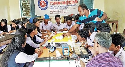 Students busy recycling old LED bulbs