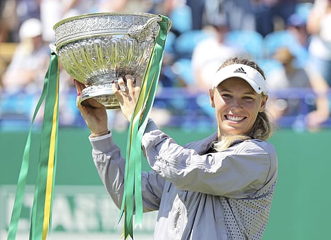 Caroline Wozniacki celebrates victory in the ladies final on day seven of the Nature Valley International at Devonshire Park in Eastbourne. | AP