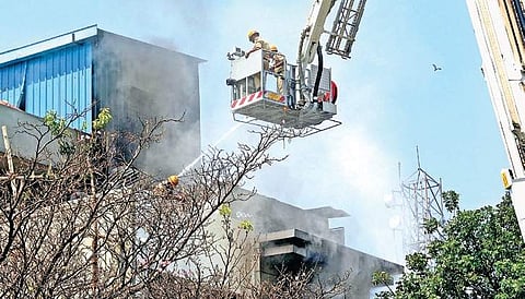 Fire service personnel dousing a fire | representative picture