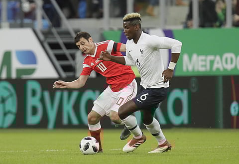 France's Paul Pogba, right, duels for the ball with Russia's Fyodor Smolov during the international friendly soccer match between Russia and France. (File | AP)
