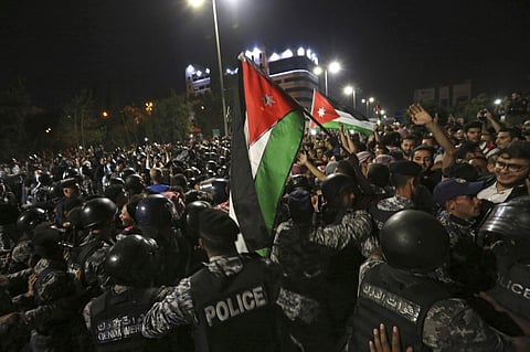 Jordanian riot police and security forces scuffle with protesters during a demonstration outside the Prime Minister's office in Amman early Tuesday. | AP