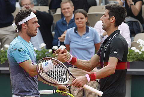 Italy's Marco Cecchinato is congratulated by Serbia's Novak Djokovic after winning his quarterfinal match of the French Open tennis tournament. | AP