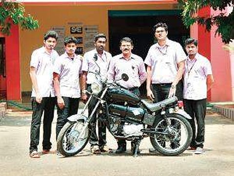 Students and Eldhose K K, the head of the mechanical engineering department of Adi Shankara Institute of Engineering and Technology, with the bike