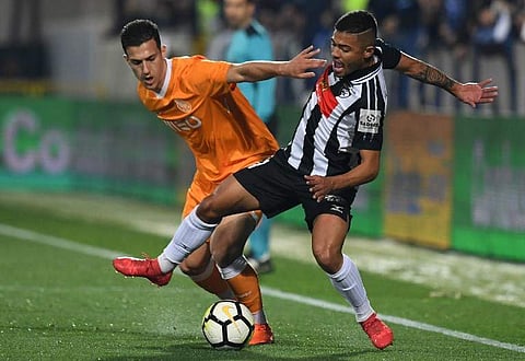 (FILES) In this file photo taken on February 25, 2018 Porto's Portuguese defender Diogo Dalot (L) vies with Portimonense's midfielder from Brazil Tabata during the Portuguese league football match between Portimonense SC and FC Porto at the Estadio Munici