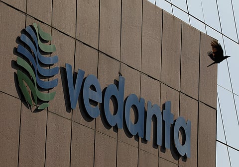 A bird flies past the logo of Vedanta installed on the facade of its headquarters in Mumbai. (File Photo | Reuters)
