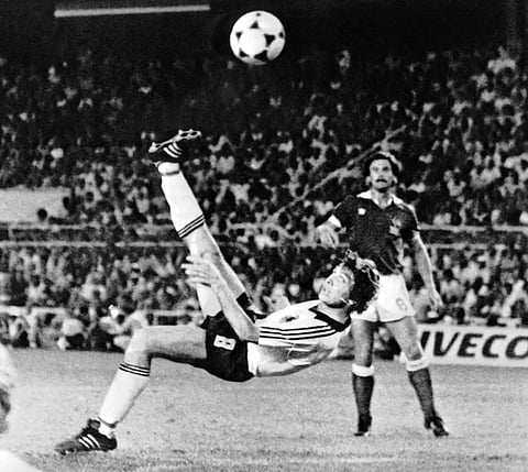 FILE - In this July 8, 1982 file photo, West Germany's Klaus Fischer scores the third goal and equalizes, in the World Cup semifinal soccer match against France, in Seville, Spain. West Germany defeats France in a penalty shoot out after a 3-3 draw. The 2