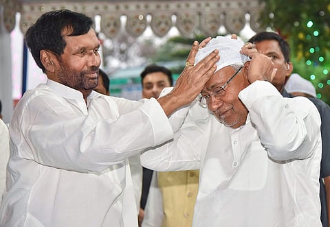 Union Food Minister and Lok Janshakti Party chief Ram Vilas Paswan presents a headgear to Bihar Chief Minister Nitish Kumar during Iftaar party in Patna on Wednesday June 06 2018. | PTI