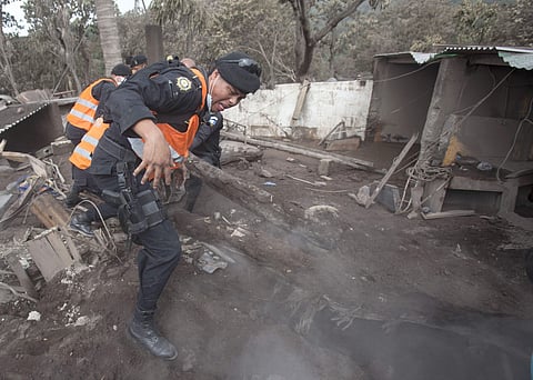 Guatemala's national disaster agency suspended search and rescue efforts at the zone devastated by the eruption of the Volcano of Fire, saying climatic conditions and still-hot volcanic material makes it dangerous for the rescuers. | AP