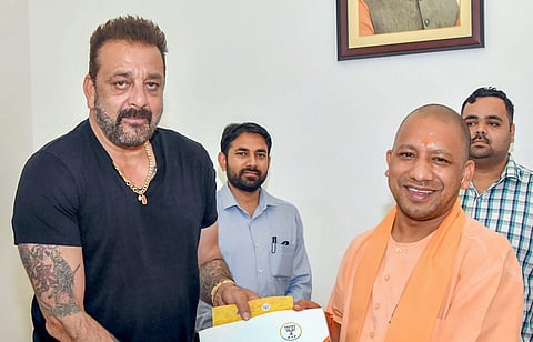 Adityanath shared a photograph in which he is seen presenting a booklet featuring Prime Minister Narendra Modi and Bharatiya Janata Party (BJP) President Amit Shah on the cover. | PTI