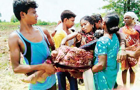 S Nagamani being taken to a hospital after she attempted suicide during a clash with forest officials at Cherupalli in Khammam district on Saturday | Express