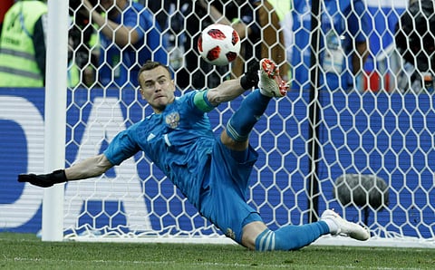 Russia goalkeeper Igor Akinfeev catches a penalty shot during the round of 16 match against Spain | AP