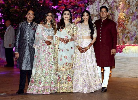 Akash Ambani with fiance Shloka Mehta pose for a photograph with family members at their engagement party in Mumbai on Saturday June 30 2018. | PTI