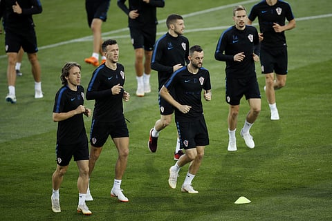 Croatia's Luka Modric, Ivan Perisic, Ante Rebic, Marcelo Brozovic and Filip Bradaric, from left, warm up during a training session in the Luzhniki sport ground at 2018 soccer World Cup in Moscow, Russia, Monday, July 9, 2018. | AP