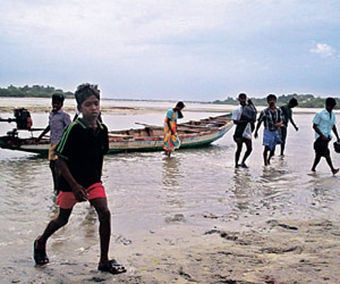 Residents of a fishing village along the Pulicat Lake alighting from their passengers boats.