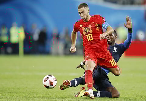 Belgium's Eden Hazard, left, is tackled by France's Paul Pogba during the first semi-final of the FIFA World Cup. | (AP)