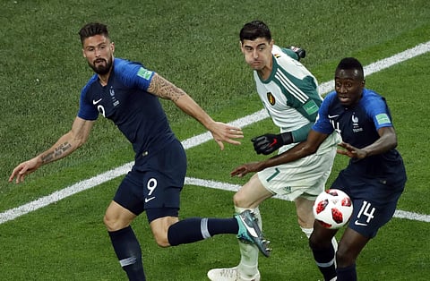 Belgium goalkeeper Thibaut Courtois, center, makes a save in front of France's Olivier Giroud, left, and Blaise Matuidi during the semifinal match between France and Belgium at the 2018 soccer World Cup in the St. Petersburg Stadium in St. Petersburg, Rus