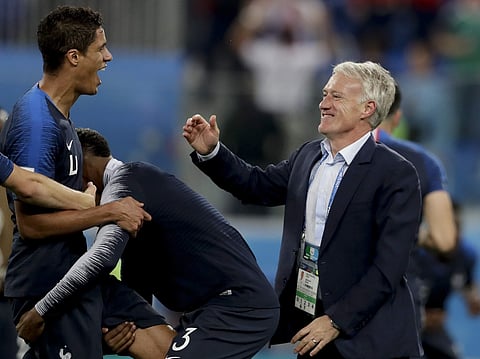 France head coach Didier Deschamps, right, and Raphael Varane celebrate at the end of the semifinal match between France and Belgium at the 2018 soccer World Cup in the St. Petersburg Stadium, in St. Petersburg, Russia, Tuesday, July 10, 2018. | AP