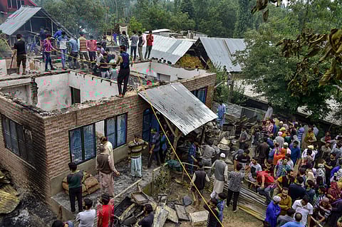 Villagers gather at the scene of an encounter between security forces and militants in Shopian district on Tuesday July 10 2018. | PTI
