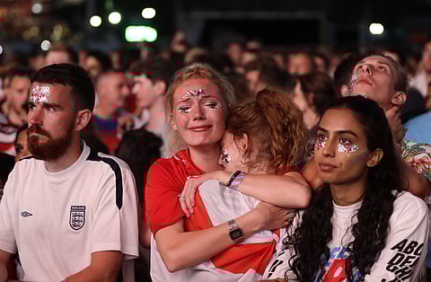 England soccer fans react after England lost the semifinal match between Croatia and England at the 2018 soccer World Cup, in Hyde Park, London, Wednesday, July 11, 2018. | AP