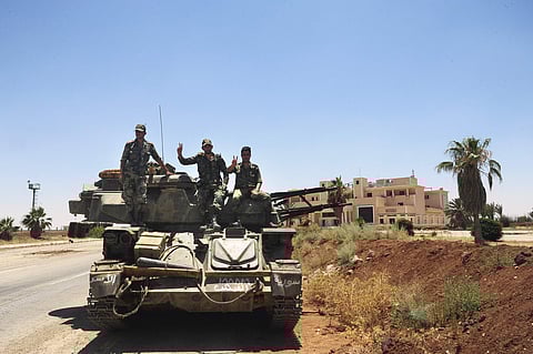 Syrian soldiers flash the victory sign at the Naseeb border crossing with Jordan, in the southern province of Daraa, Syria. (Photo | AP)