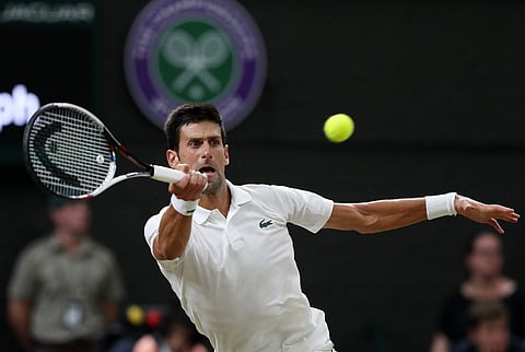Novak Djokovic of Serbia returns a ball to Rafael Nadal of Spain during their men's singles semifinal match at the Wimbledon Tennis Championships, in London, Friday July 13, 2018. | AP