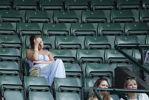 Spectators attend the men's singles quarterfinal tennis match between John Isner of the United States and Canada's Milos Raonic, at the Wimbledon Tennis Championships, in London. (Photo | AP)