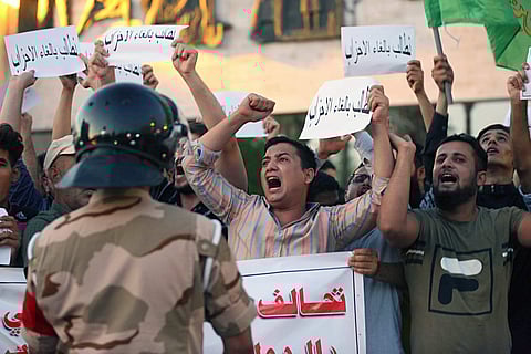 Iraqi protesters chant slogans demanding services and jobs during a demonstration in Tahrir Square. (Photo | AP)