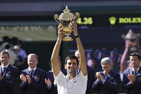 Serbia's Novak Djokovic lifts the trophy after winning the men's singles final match against Kevin Anderson of South Africa | AP