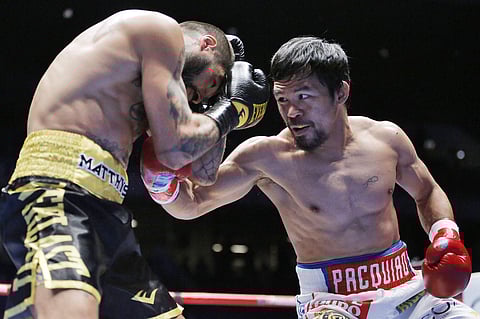 Manny Pacquiao of the Philippines, right, strikes Lucas Matthysse of Argentina during their WBA World welterweight title bout in Kuala Lumpur, Malaysia. | AP