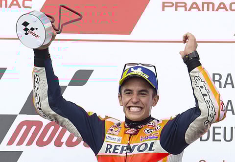 Winner and Honda rider Marc Marquez of Spain celebrates on the podium during the MotoGP at German Motorcycle Grand Prix at the Sachsenring circuit in Hohenstein-Ernstthal. | AP