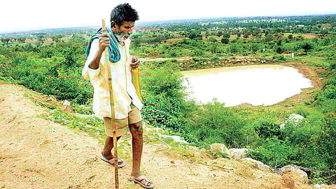 Kamegowda has built 14 ponds on the barren Kundinibetta hill in Malavalli taluk of Mandya district. (Photo | Pandarinath B/EPS)
