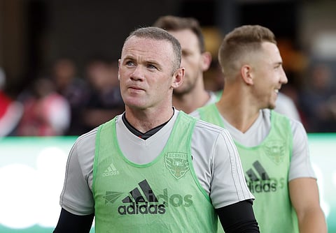 D.C. United forward Wayne Rooney, left, walks on the field before an MLS soccer match against the Vancouver Whitecaps at Audi Field, Saturday, July 14, 2018, in Washington. (Photo | AP)