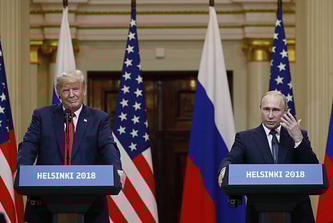 U.S. President Donald Trump, left, listens to Russian President Vladimir Putin during a press conference after their meeting at the Presidential Palace in Helsinki, Finland. (Photo | AP)