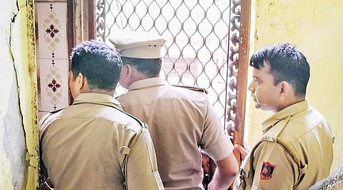 Policemen inspect the Tilak Nagar police station where a teenaged girl allegedly committed suicide late on Sunday in New Delhi | PTI