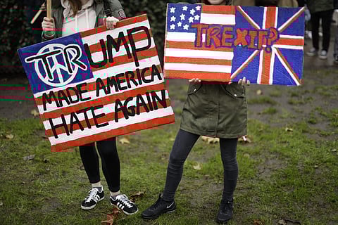 demonstrators hold placards as they take part in a protest outside the U.S. embassy in London, against U.S. President Donald Trump's ban on travellers and immigrants from seven predominantly Muslim countries entering the U.S. ( Photo | AP)