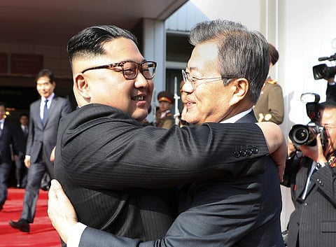 North Korean leader Kim Jong Un, and South Korean President Moon Jae-in embrace each other. (File photo | AP)
