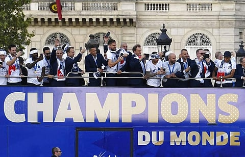 France's players celebrate on the roof of a bus while parading down the Champs-Elysee avenue in Paris. (Photo | AP)