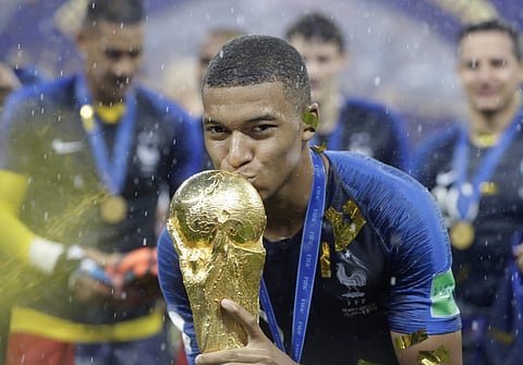 France's Kylian Mbappe kisses the trophy after the final match between France and Croatia at the 2018 soccer World Cup in the Luzhniki Stadium in Moscow, Russia, Sunday, July 15, 2018. | Associated Press