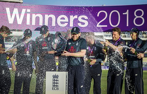 Eoin Morgan holds the trophy as he celebrates winning the ODI series against India, with team mates at Headingley in Leeds, England, Tuesday July 17, 2018. | AP