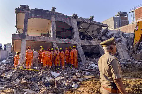 Rescue workers search for survivors under the debris of a collapsed building at Shahberi village in Greater Noida West on Wednesday July 18 2018. (Photo| PTI)