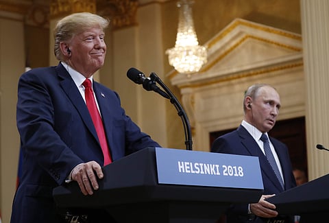 U.S. President Donald Trump, left, smiles beside Russian President Vladimir Putin during a press conference after their meeting at the Presidential Palace in Helsinki, Finland. (Photo | AP)