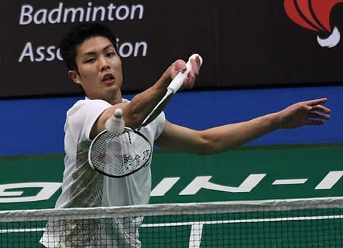 Taiwan's Chou Tien Chen hits a return against South Korea's Lee Hyun Il during the men's singles quarterfinal at the Singapore Open badminton tournament. | AFP